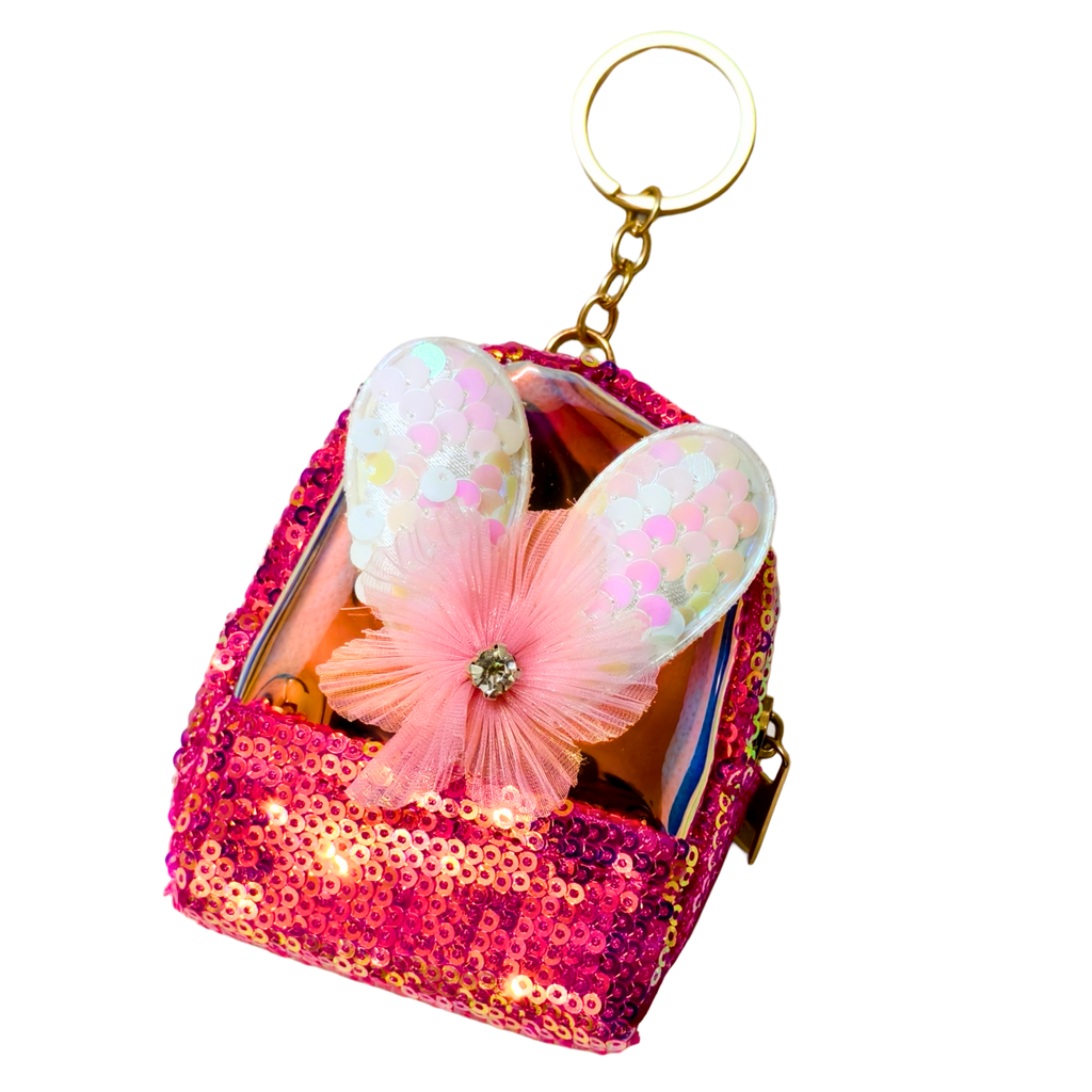 Sparkly pink keychain with a decorative flower on a white background