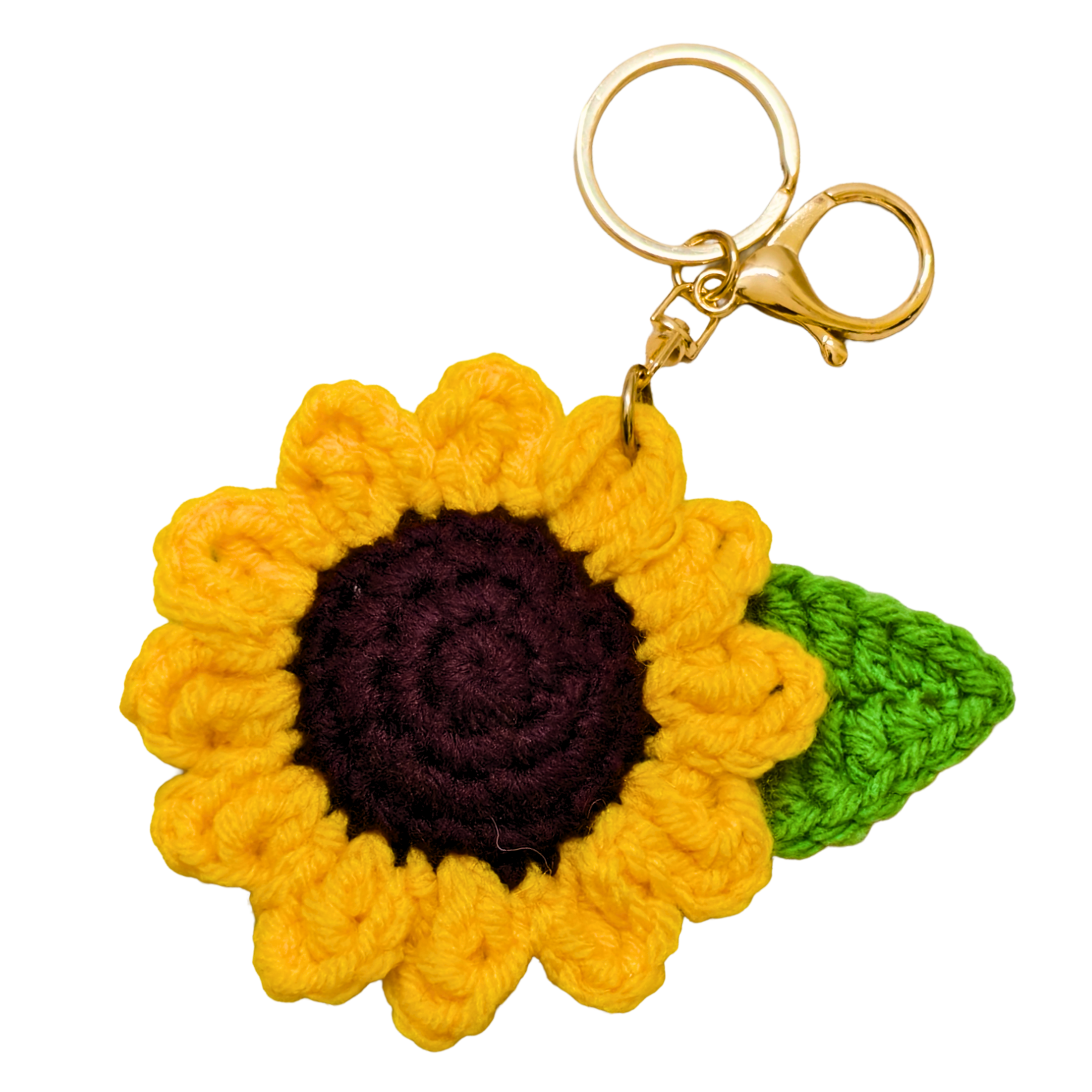 Crocheted sunflower keychain with a green leaf on a white background