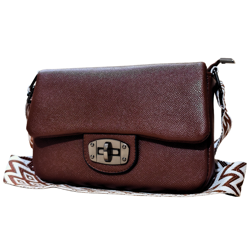 Brown leather handbag with a decorative strap on a white background