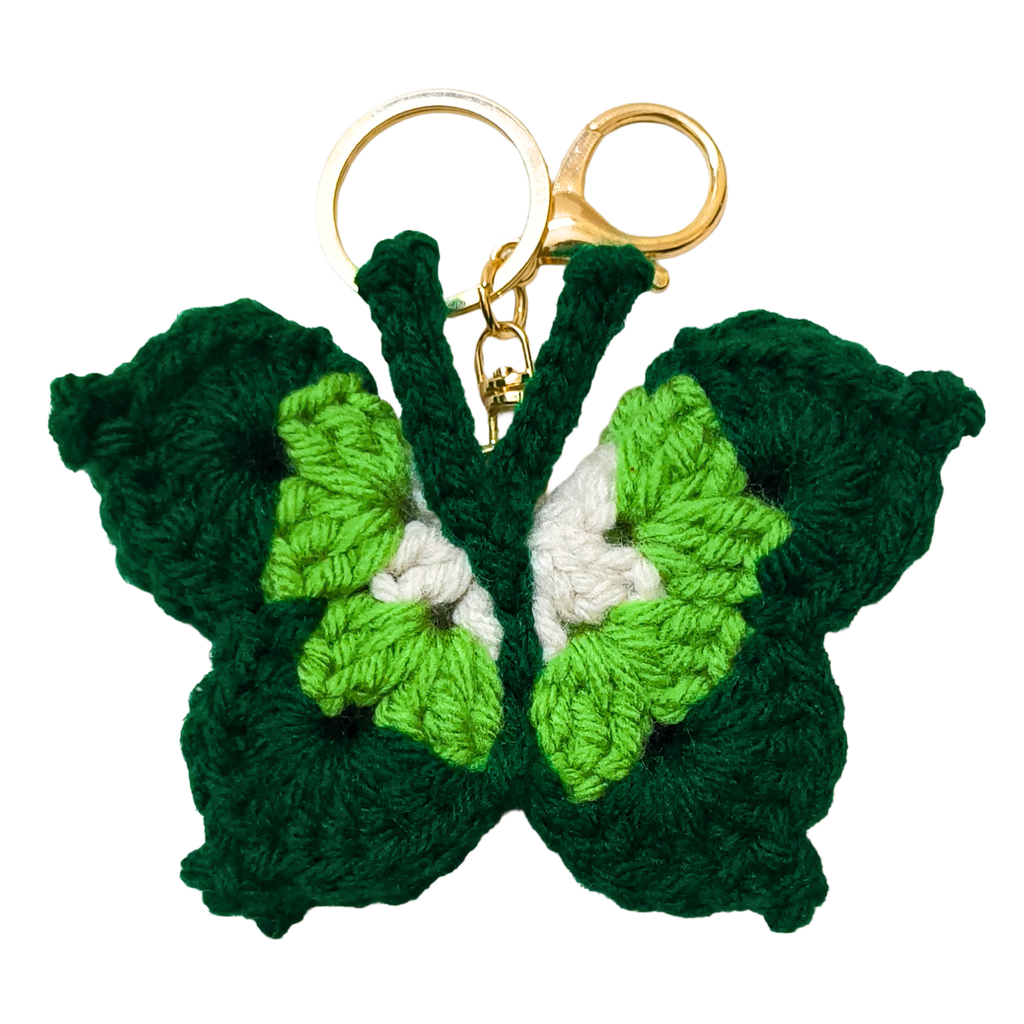 Green butterfly-shaped keychain with gold ring on a white background