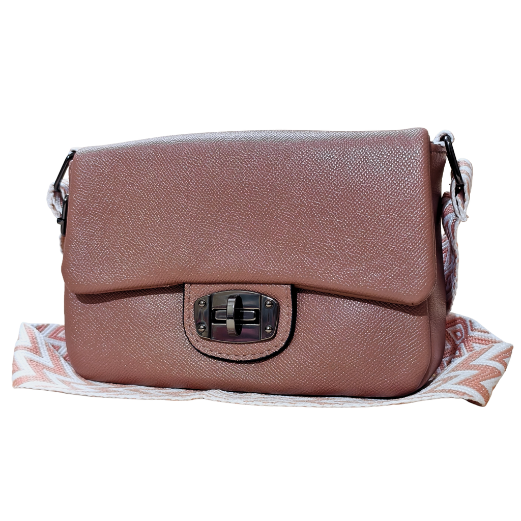 Brown leather handbag with a decorative strap on a white background