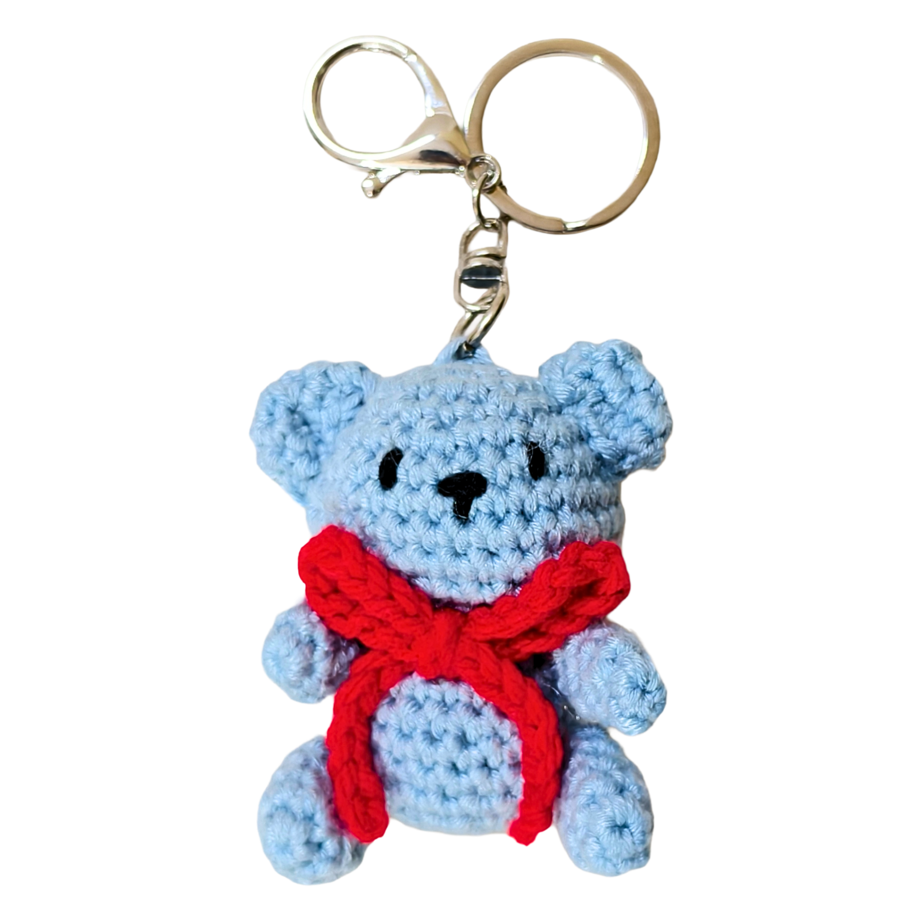 Blue teddy bear keychain with a red scarf on a white background