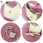 Beige handbag with metal embellishments, silver plated zipper, faux leather strap, and teddy bear keychain on a pink background.