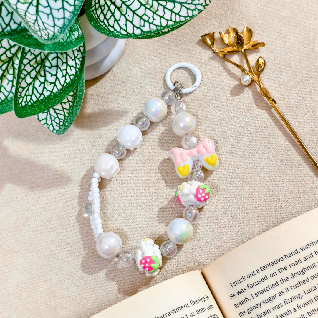 Bracelet with decorative elements on a textured surface with a book and plant