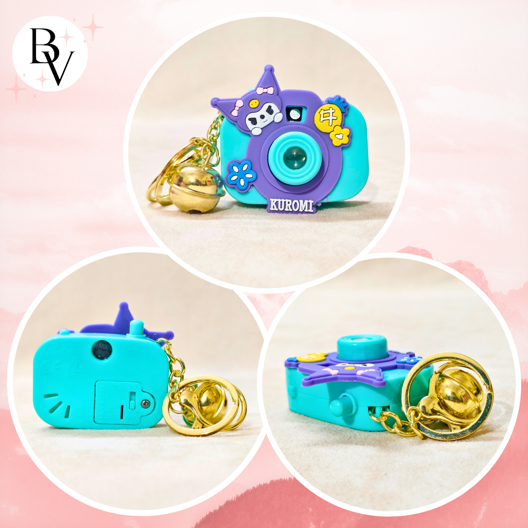 Colorful camera-shaped keychain with 'Kuromi' branding on a pink background