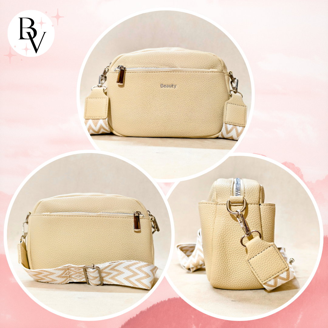 A beige pebbled faux-leather crossbody bag shown in three circular views on a soft pink background. The bag has a top zipper, a matching beige-and-white chevron patterned strap, and small gold-tone hardware.