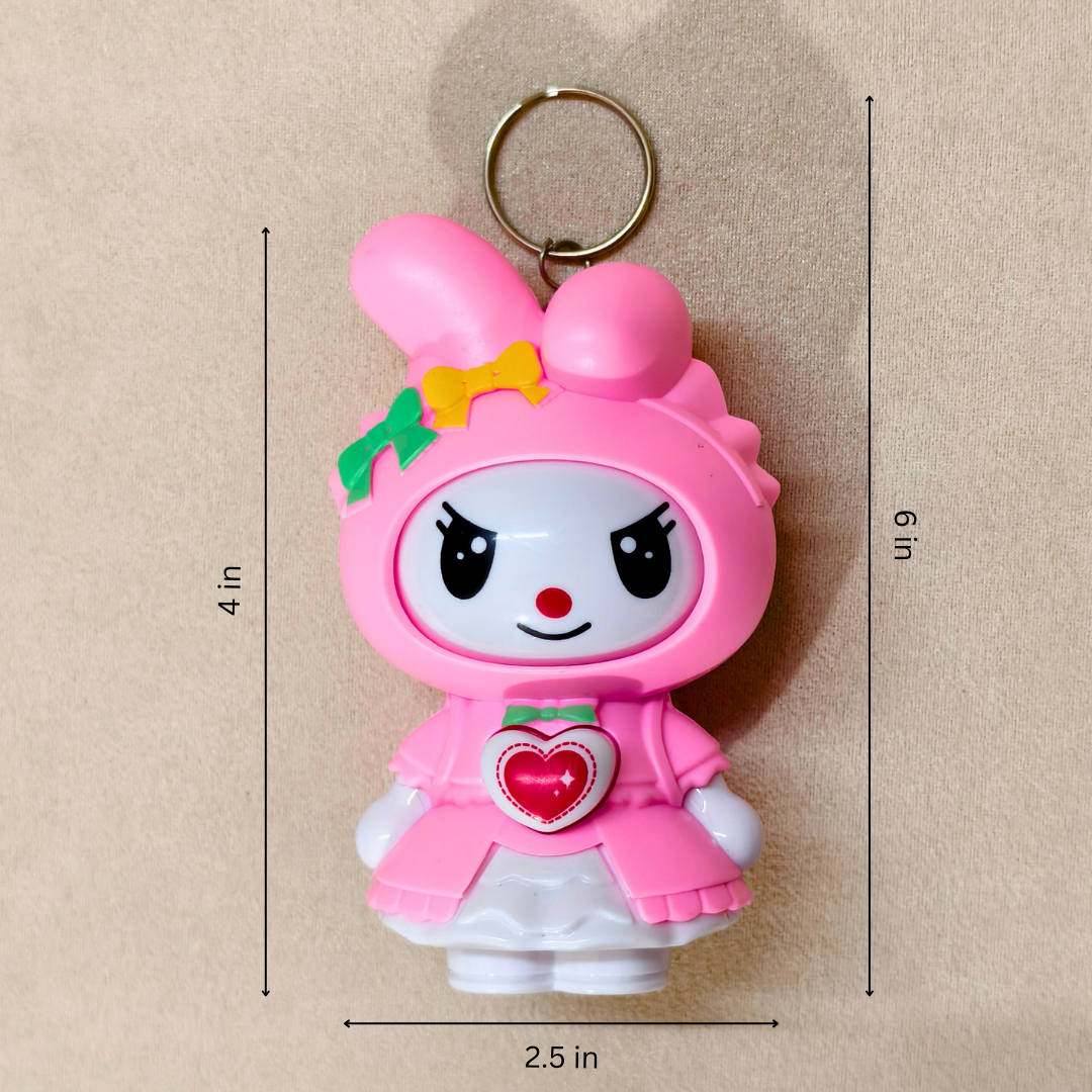 Pink cartoon character keychain with measurements on a beige background