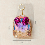 Sequined keychain with heart design and measurements on a beige background