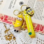 Yellow Character Minion Keychain  With Props  On Beige Background.