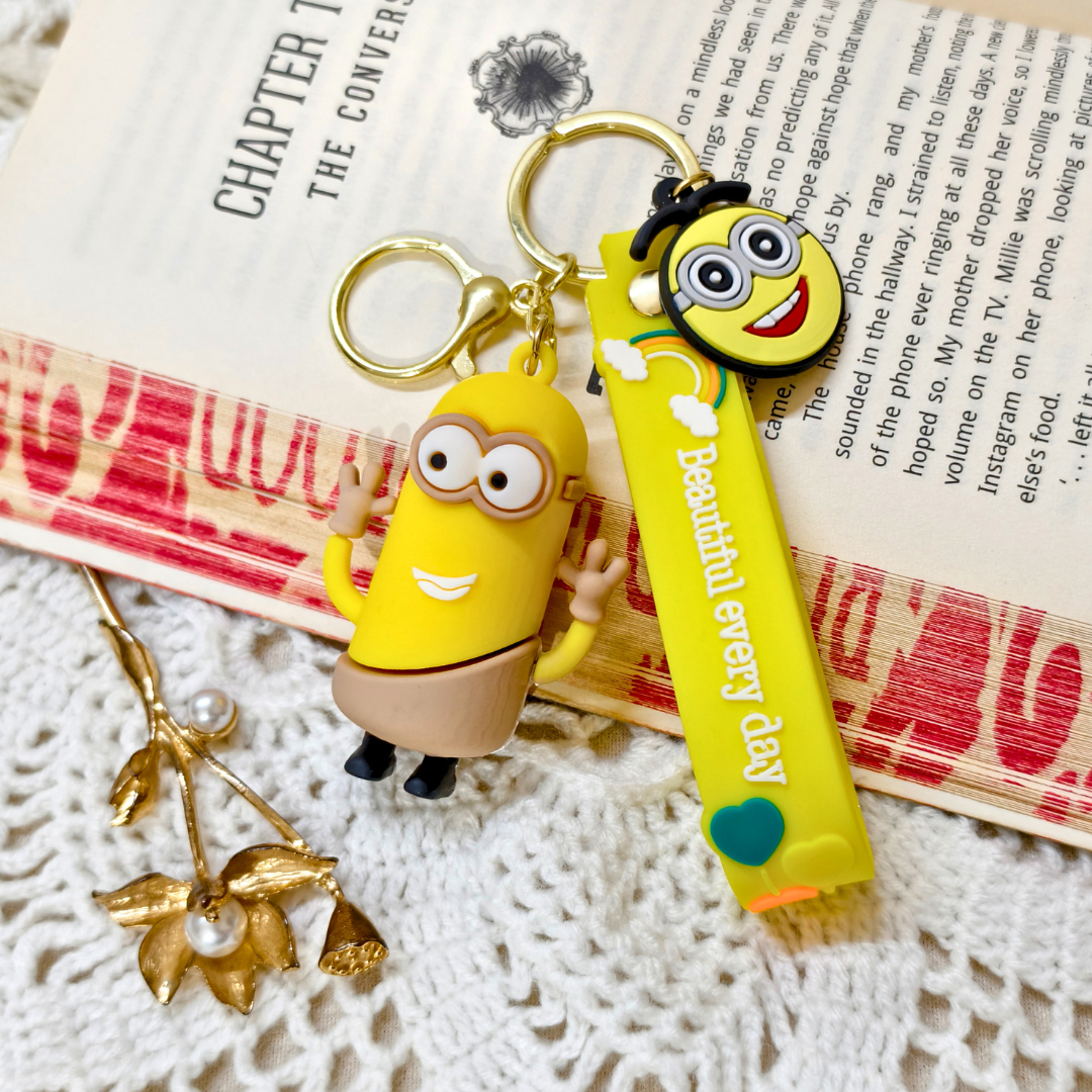 Yellow Character Minion Keychain  With Props  On Beige Background.