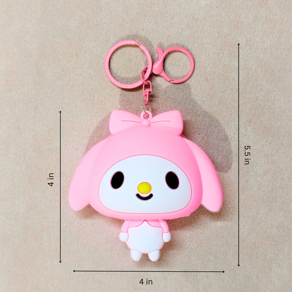 Pink cartoon character keychain with measurements on a beige background