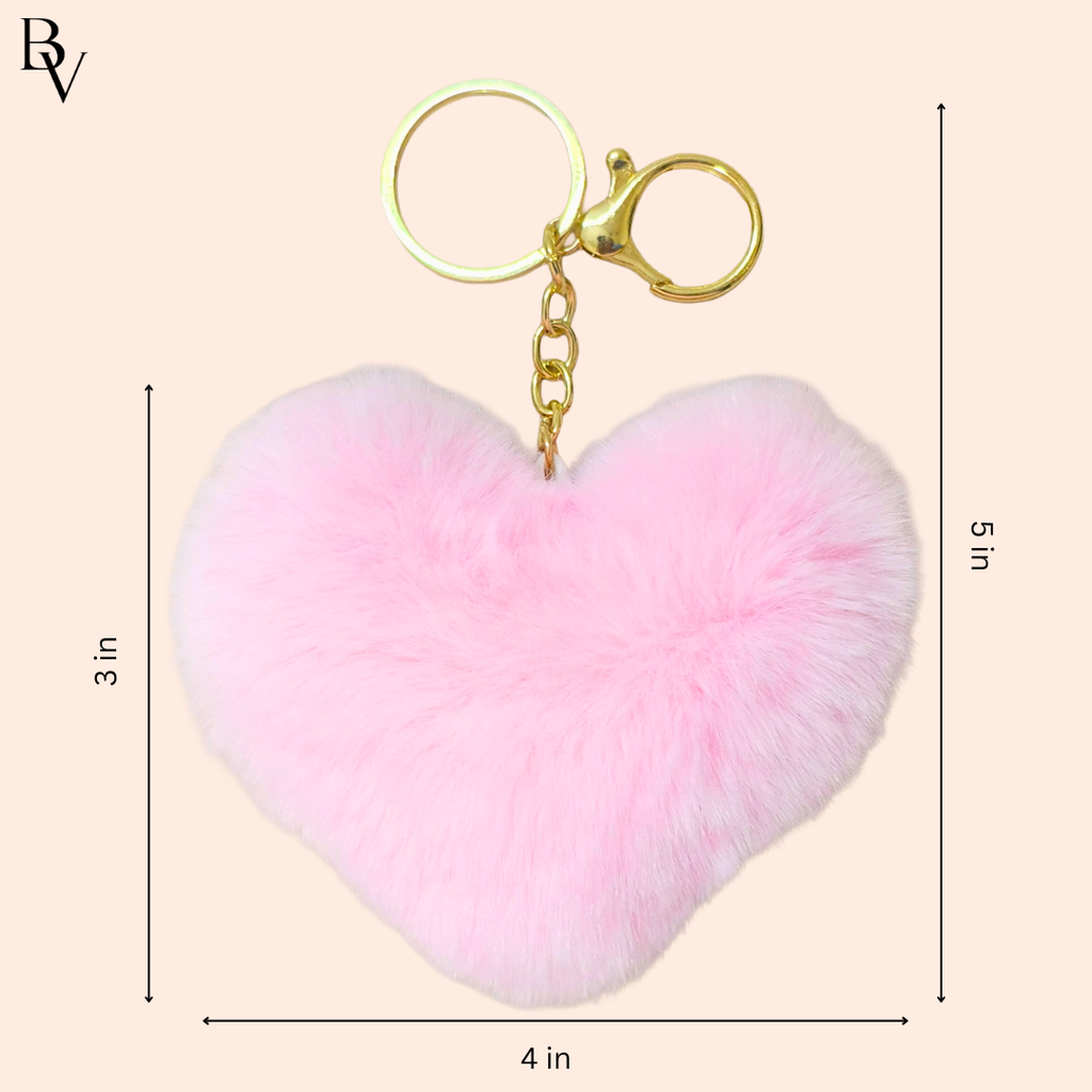 Heart-shaped pink fluffy keychain with gold clasp on a beige background, featuring measurements.
