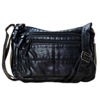 Black leather handbag with multiple zippers on a white background