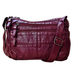 Maroon leather handbag with multiple compartments on a white background