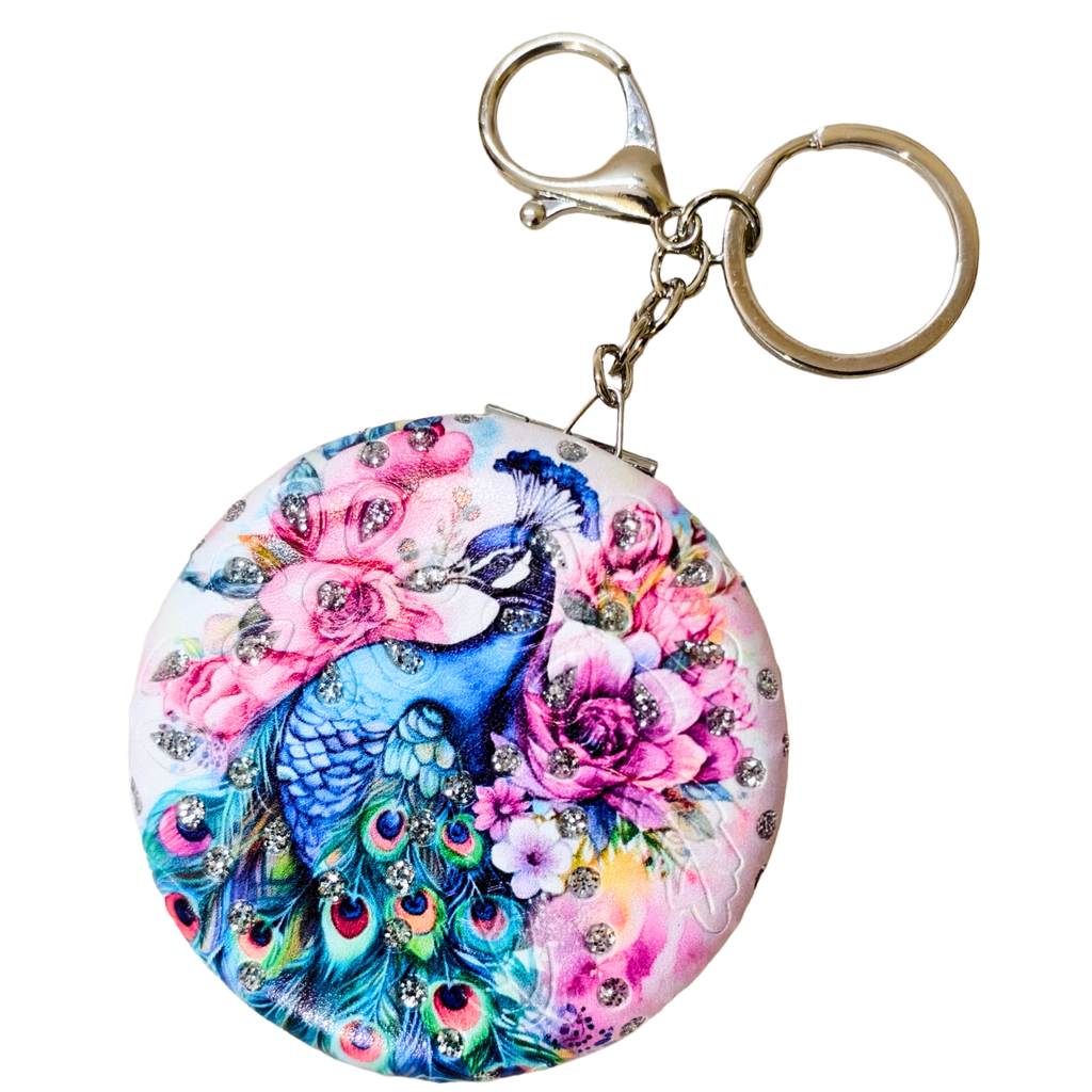 Keychain with peacock and floral design on a white background