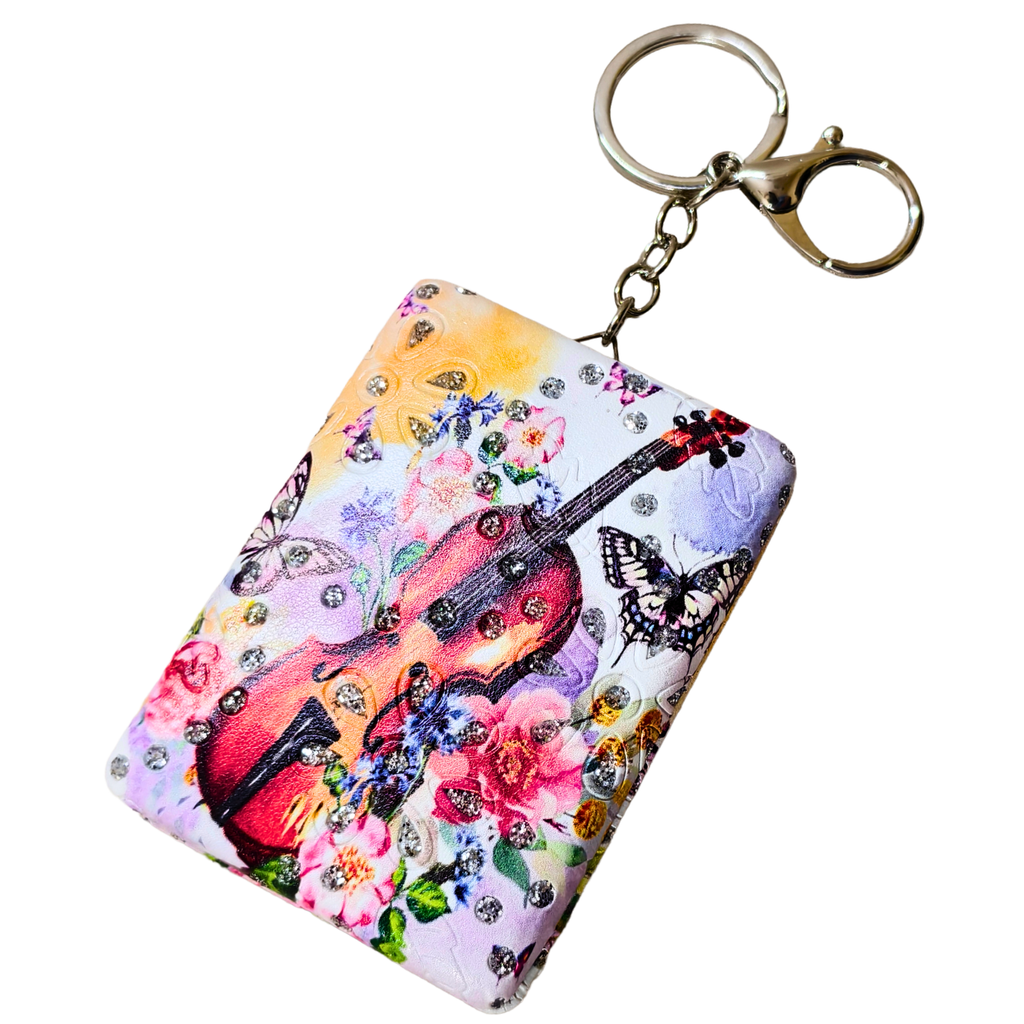 Keychain with floral and guitar design on a white background
