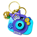Colorful keychain camera with cartoon character and bell on a white background