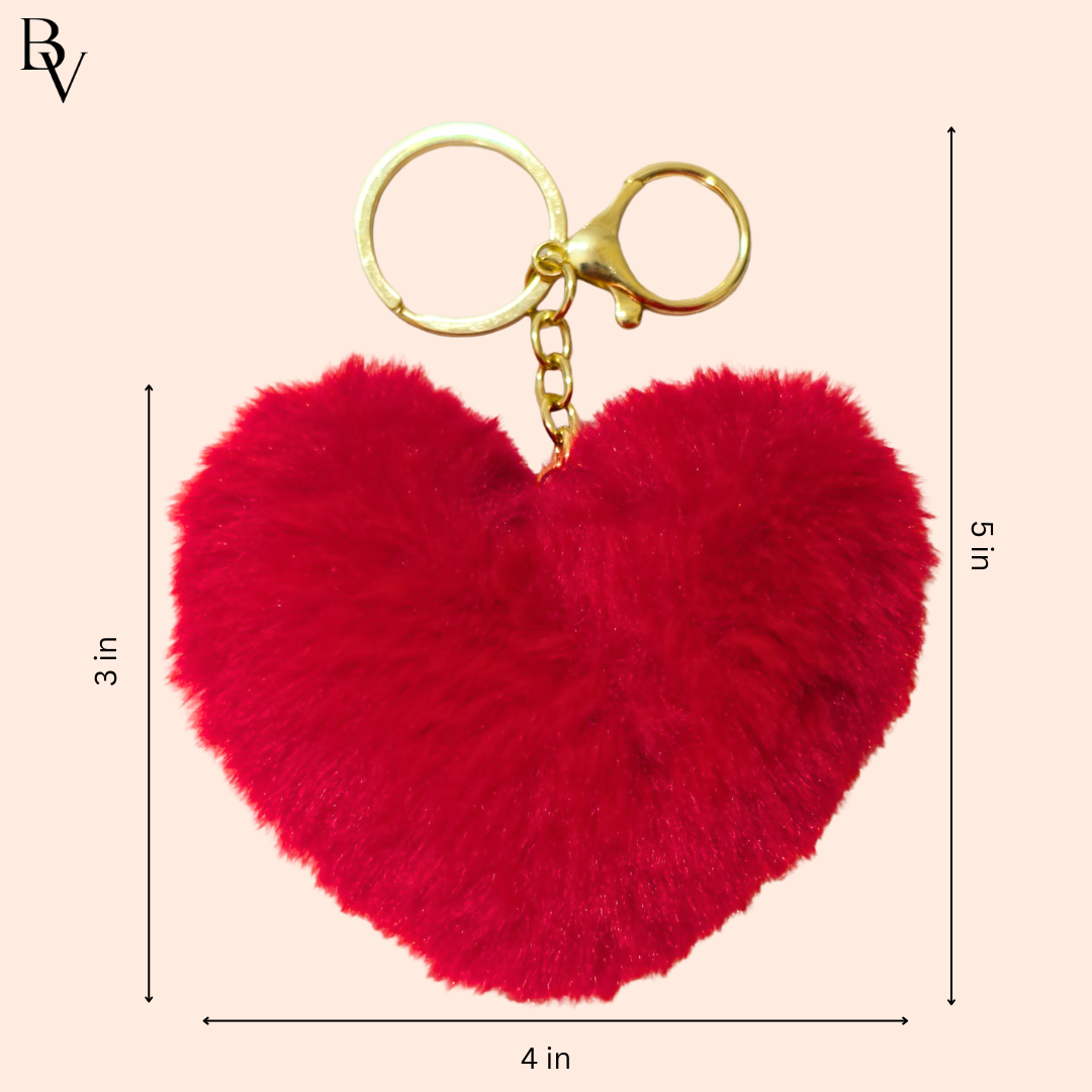 Red heart-shaped fluffy keychain with gold clasp on a beige background, showing measurements.