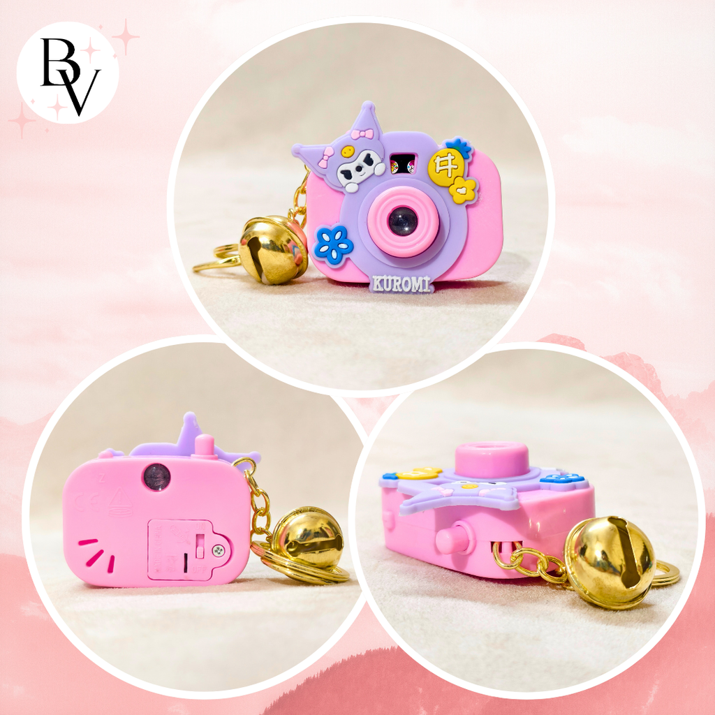 Pink toy camera with keychain on a pink background