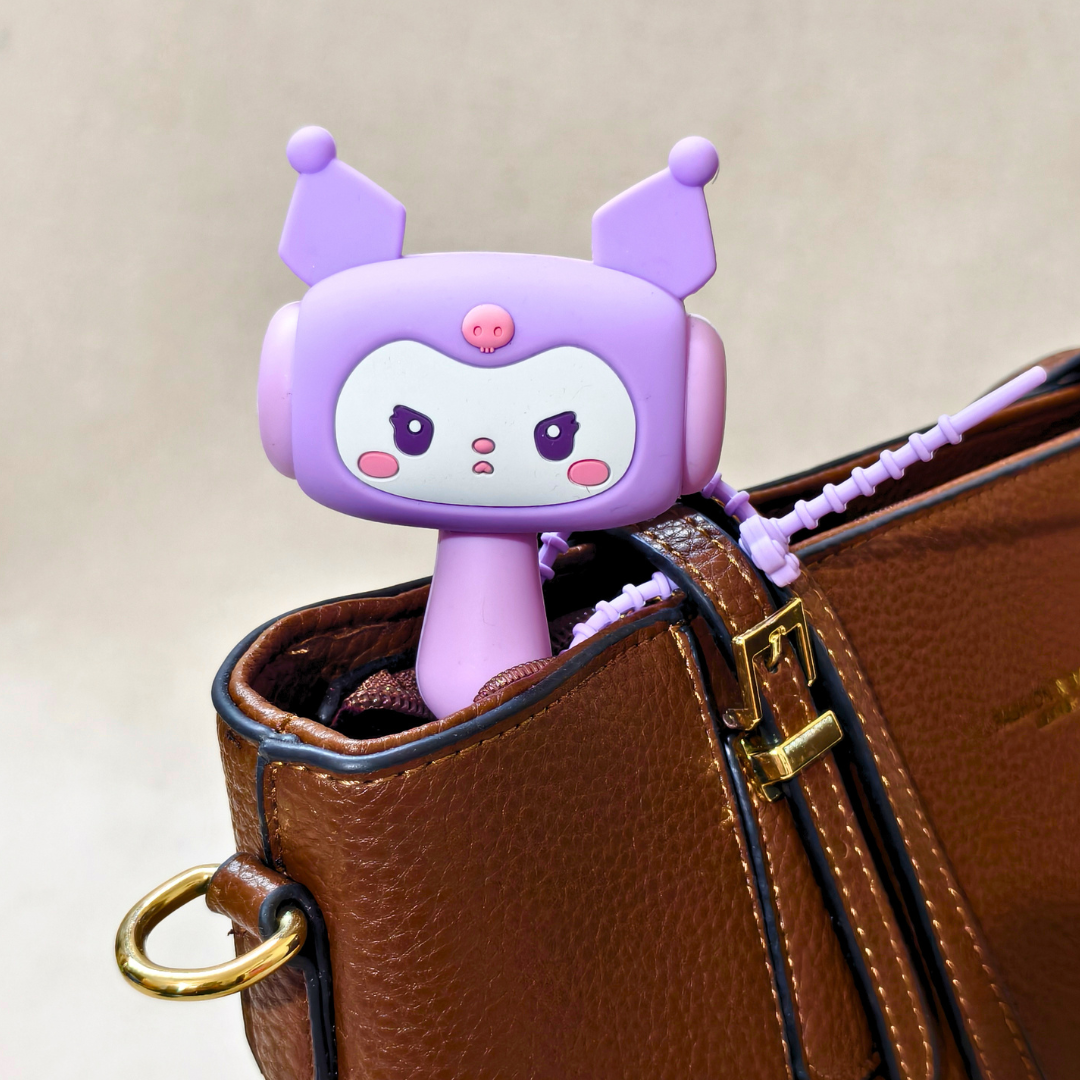 Purple cartoon character with antenna on a brown leather bag