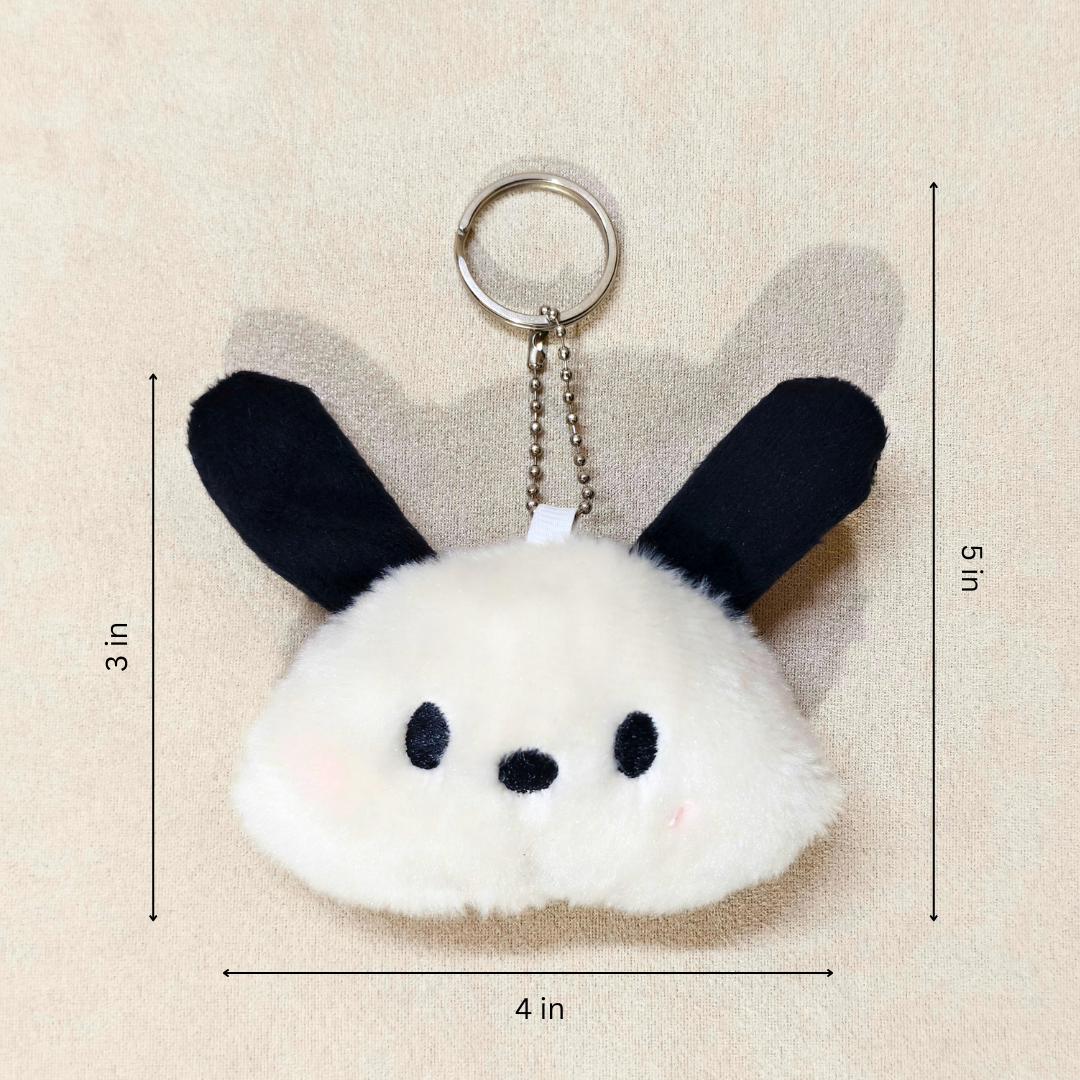 Plush keychain with bunny ears and measurements on a beige background