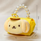 Plush keychain with a face design on a beige background