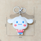 White cartoon character keychain with measurements on a beige background