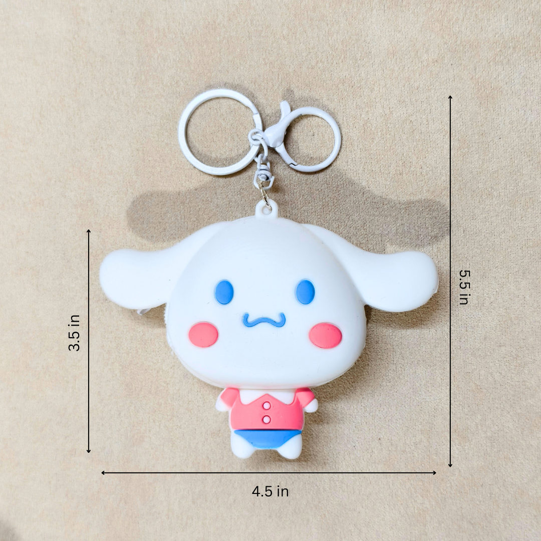 White cartoon character keychain with measurements on a beige background