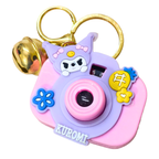Pink and purple camera-shaped keychain with cartoon character and 'Kuromi' branding on a white background