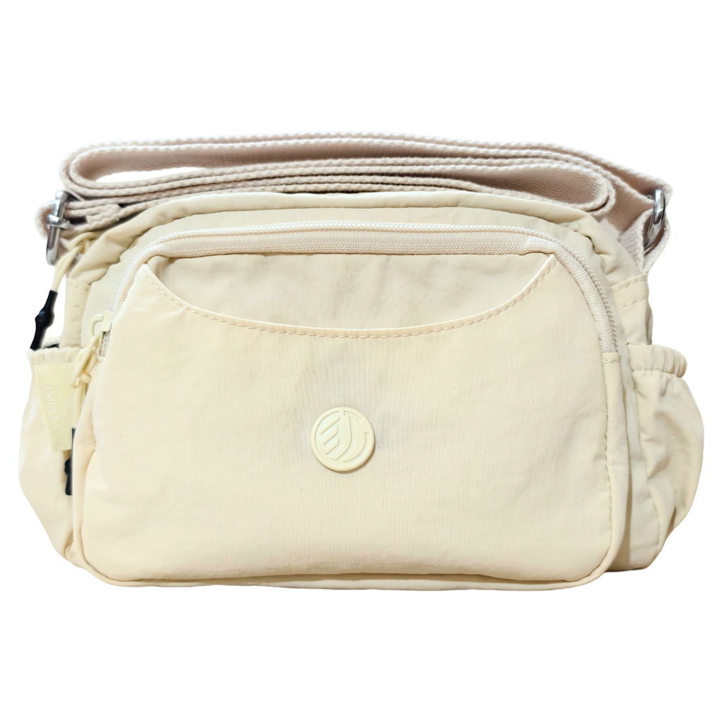 Cream Ivory Sling Bag In Front Of White Background.