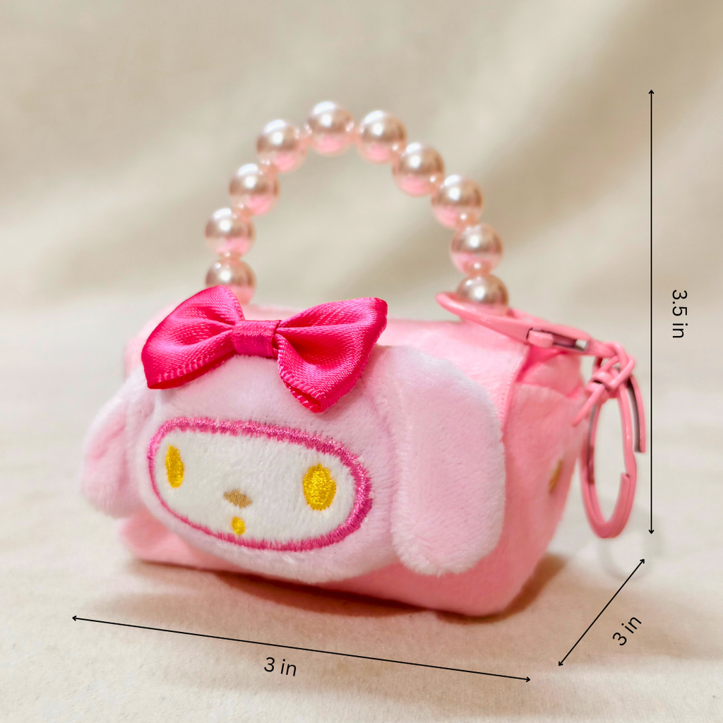 Pink plush keychain with a bow and measurements on a beige background