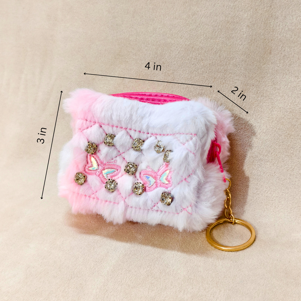 Pink and white textured pouch with decorative elements and a gold keychain on a beige background