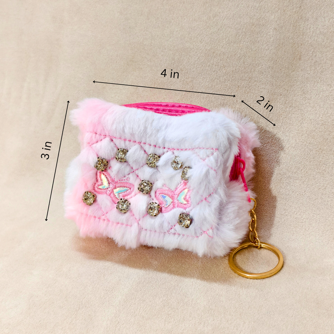 Pink and white textured pouch with decorative elements and a gold keychain on a beige background