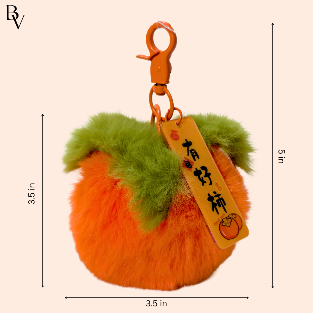 Fluffy orange and green keychain with a tag on a beige background