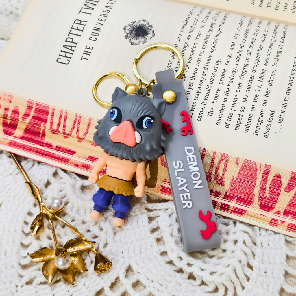 Keychain with a character design on a book with visible text