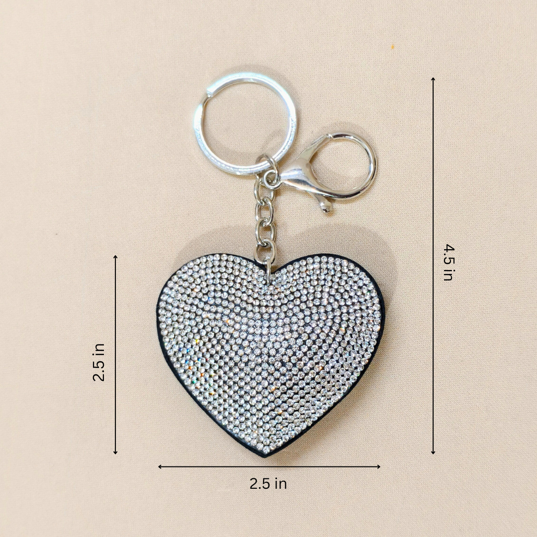White Heart Keychain with a metal latch in front of a beige background along with measurements