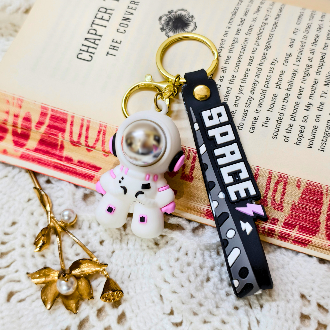 Small Astronaut Keyring With Props On Crochet Background.