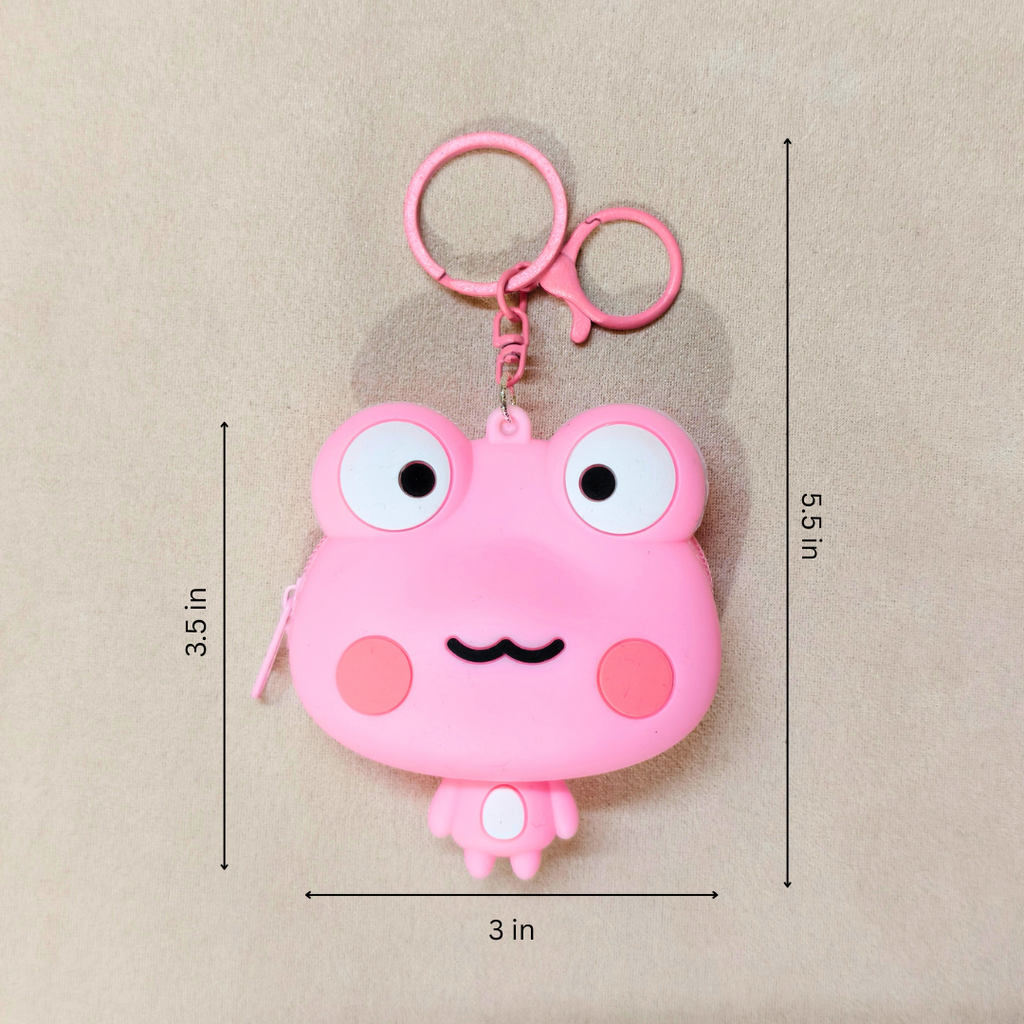 Pink cartoon frog-shaped keychain with measurements on a beige background