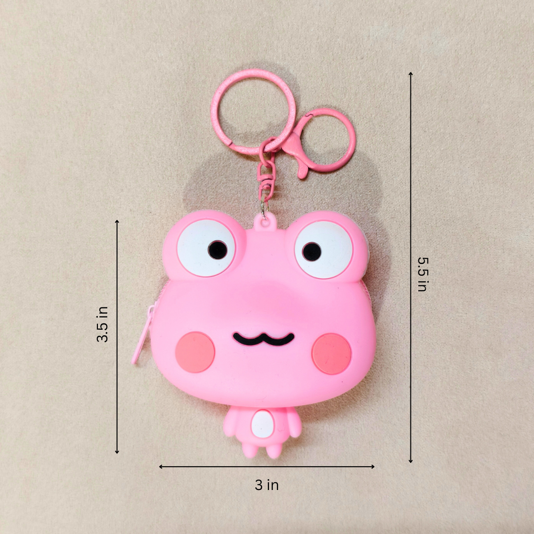 Pink cartoon frog-shaped keychain with measurements on a beige background