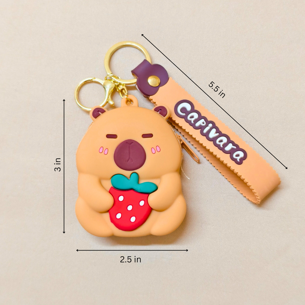 Silicone keychain with bear design holding a strawberry, labeled 'Capivara', on a beige background.