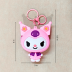Pink cartoon character keychain with measurements on a beige background