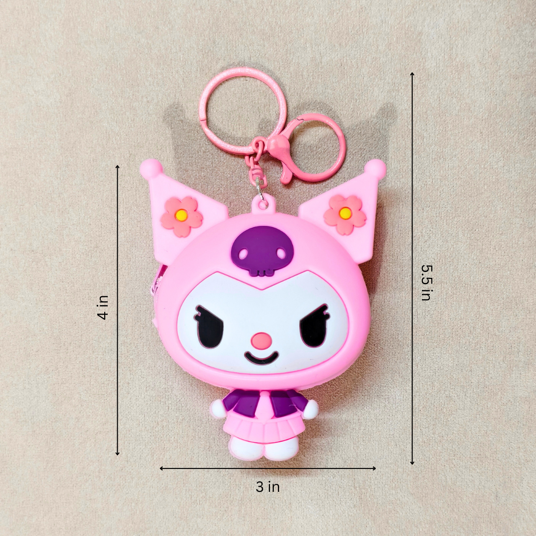 Pink cartoon character keychain with measurements on a beige background