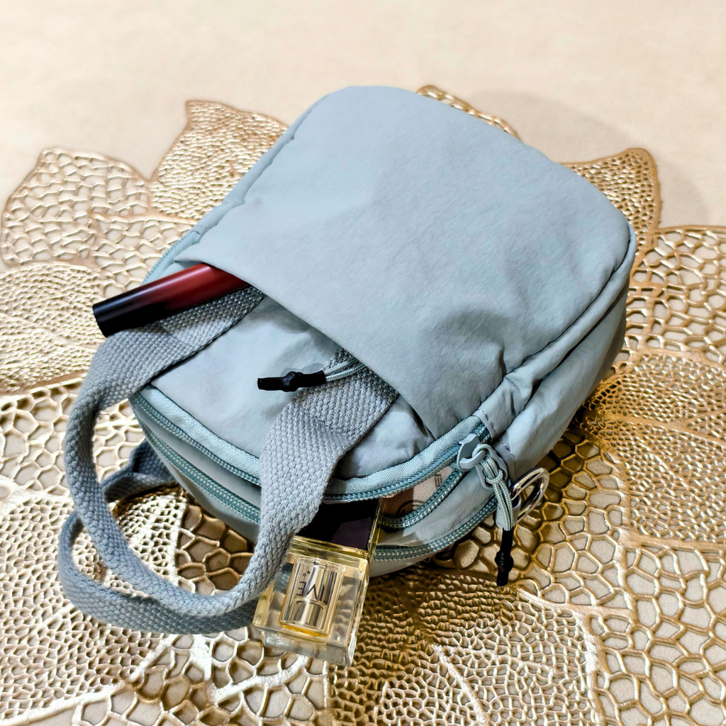 Light blue backpack with a lock on a textured surface