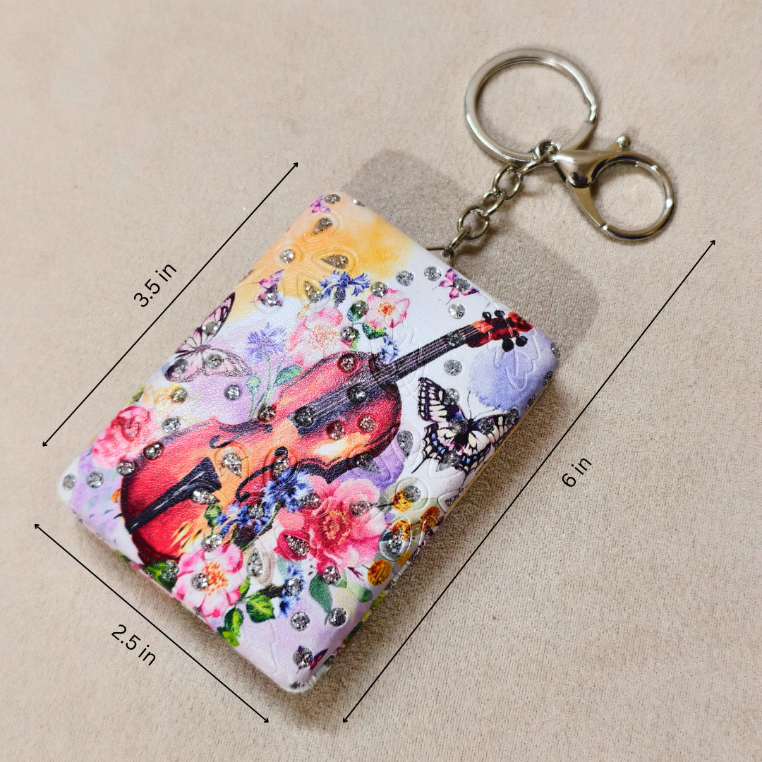 Keychain with colorful guitar design and butterfly patterns, shown with measurements on a beige background.