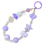 Children's teething bracelet with purple and white charms on a white background