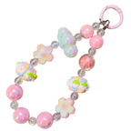 Colorful beaded bracelet with floral designs on a white background