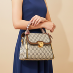 Woman holding a patterned handbag against a beige background