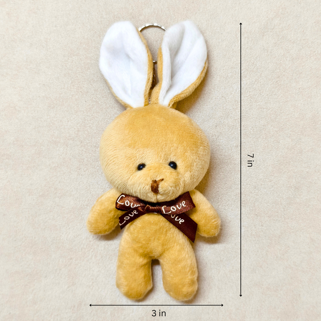 Plush bunny toy with a brown bow and measurement details on a beige background