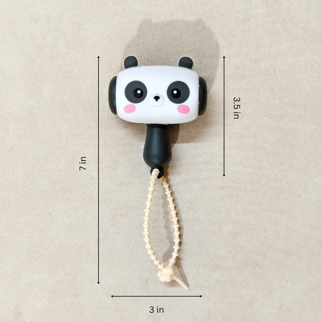 Panda-shaped toy with measurements on a beige background