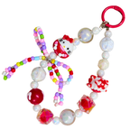 Colorful beaded keychain with Hello Kitty figures on a white background
